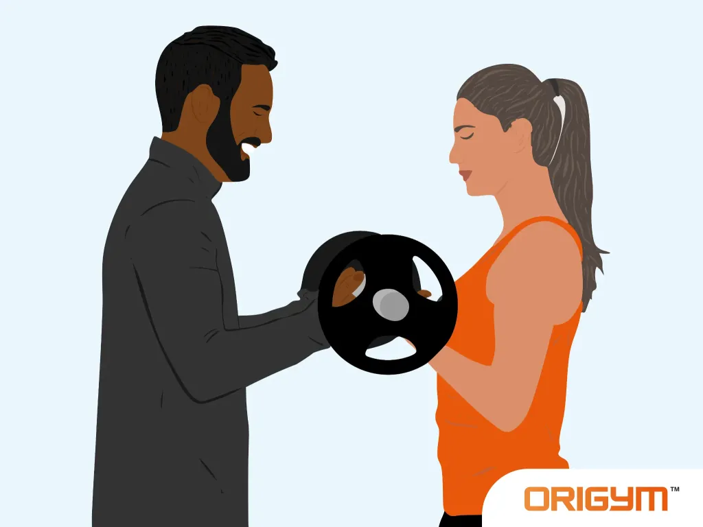 Male Fitness Instructor Helping a Female Client Lift Weights