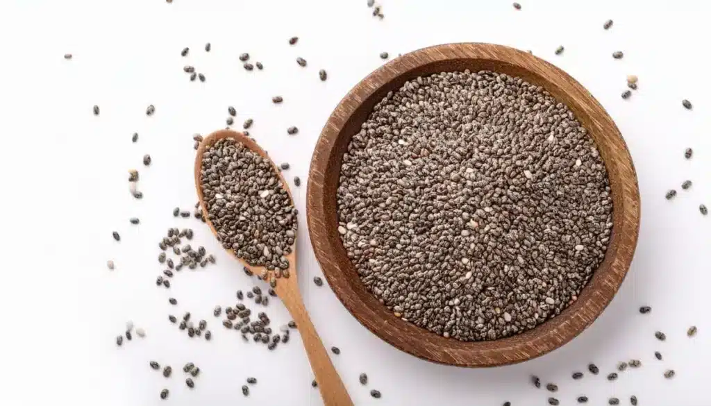 Image of a Wooden Bowl of Chia Seeds With a Wooden Spoon Beside It
